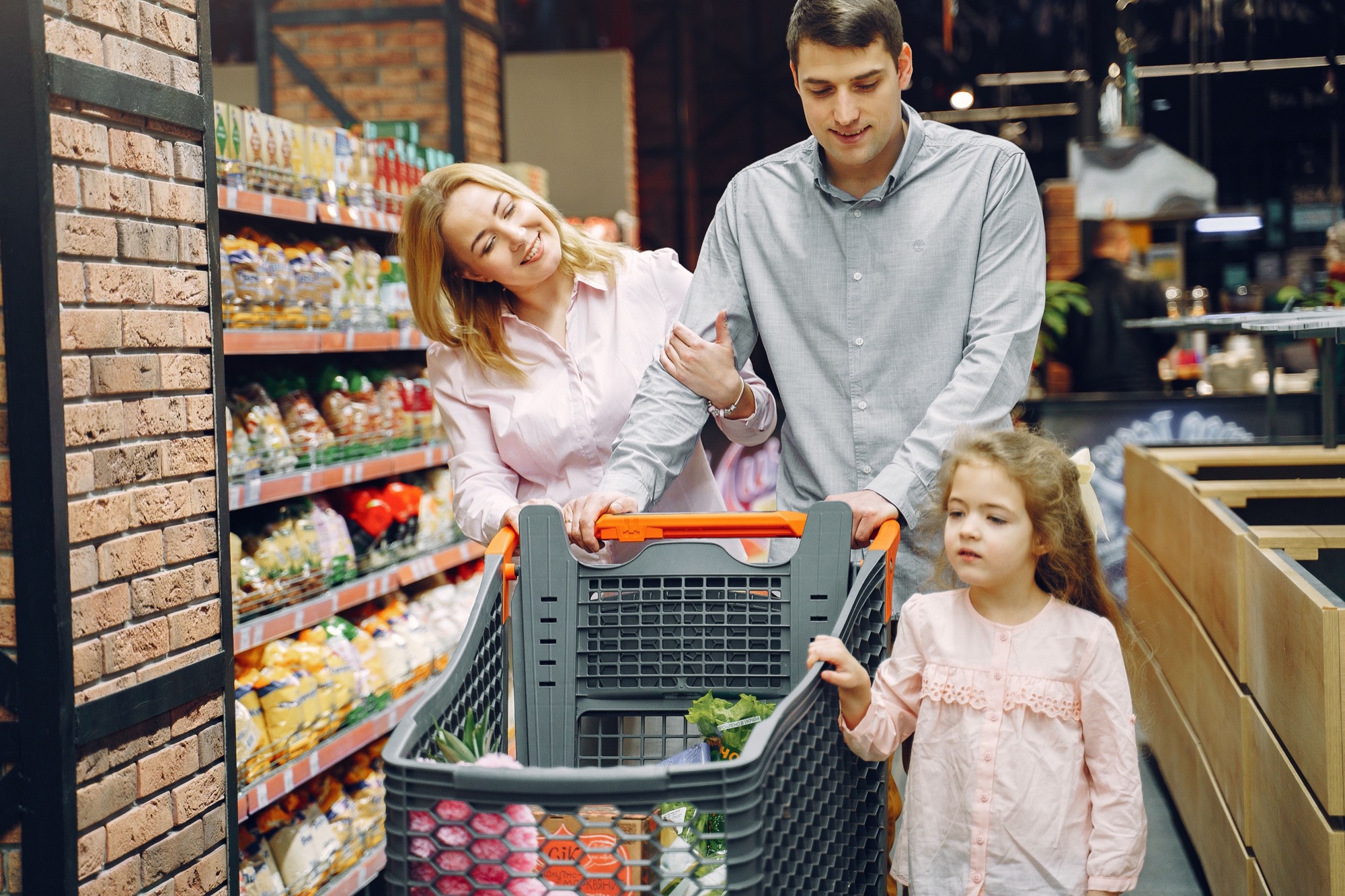 Familia recorriendo las góndolas de un supermercado